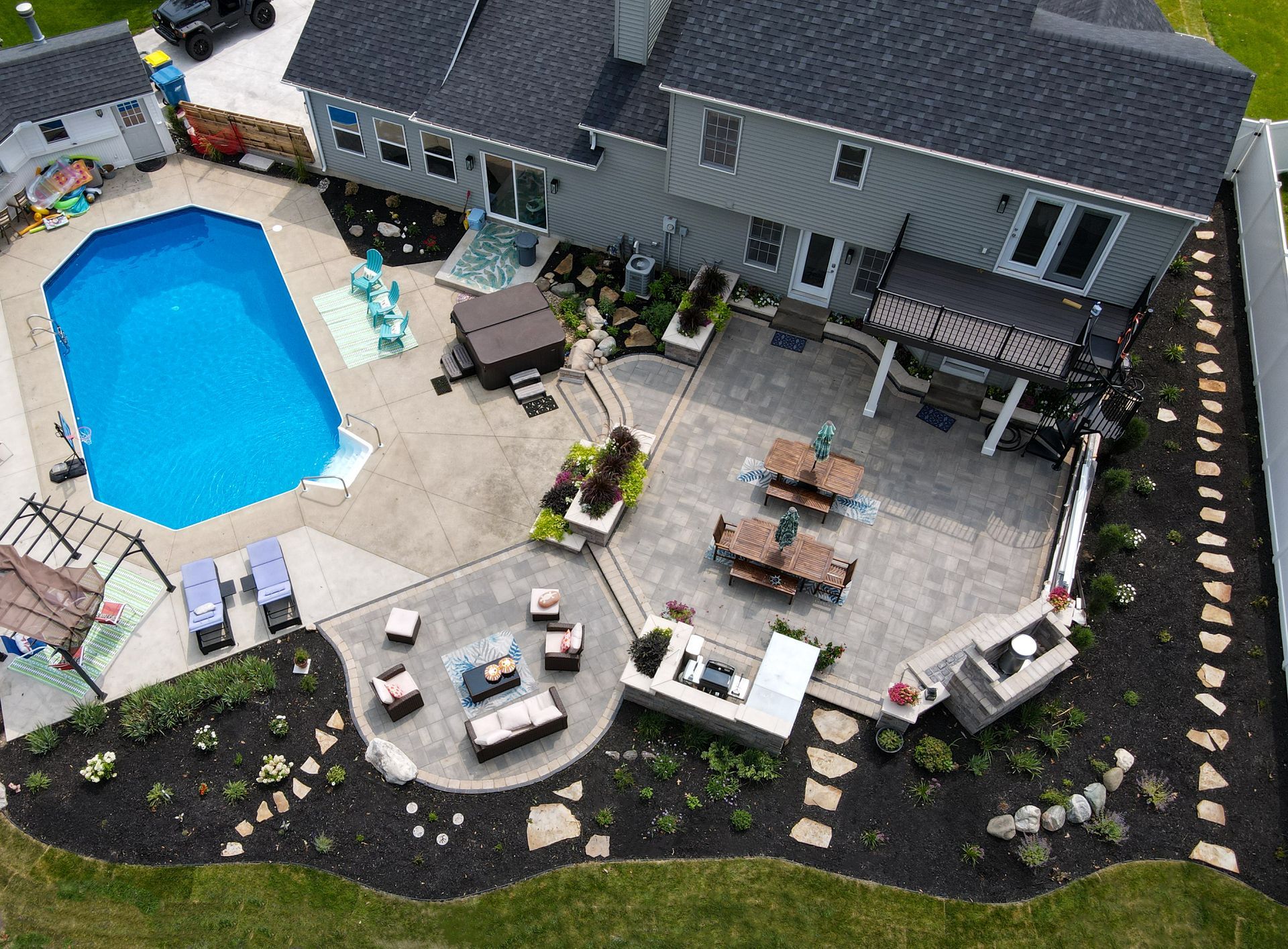 An aerial view of a house with a large pool and patio area.