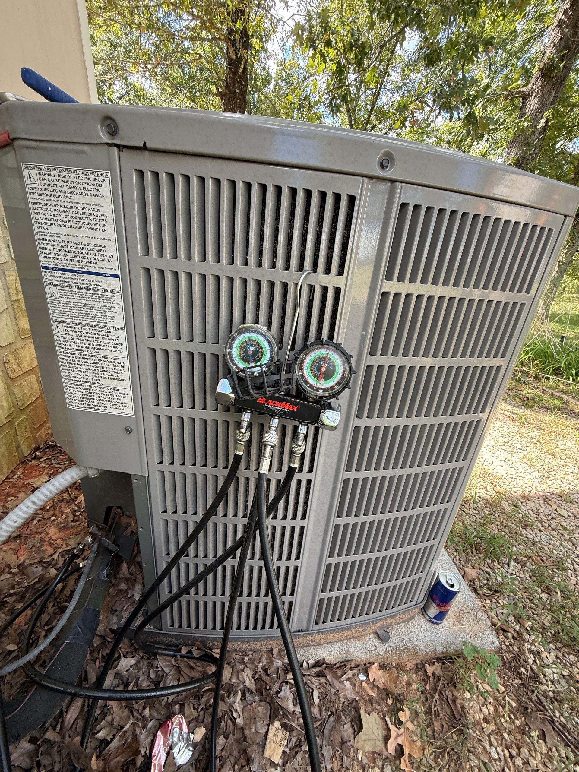 A white truck is parked in a parking lot next to a building.