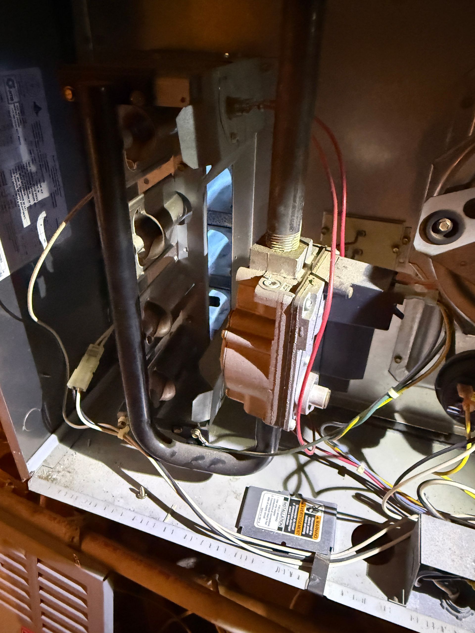 Open computer tower with exposed wires, drive bays, and internal components inside a desk cabinet.