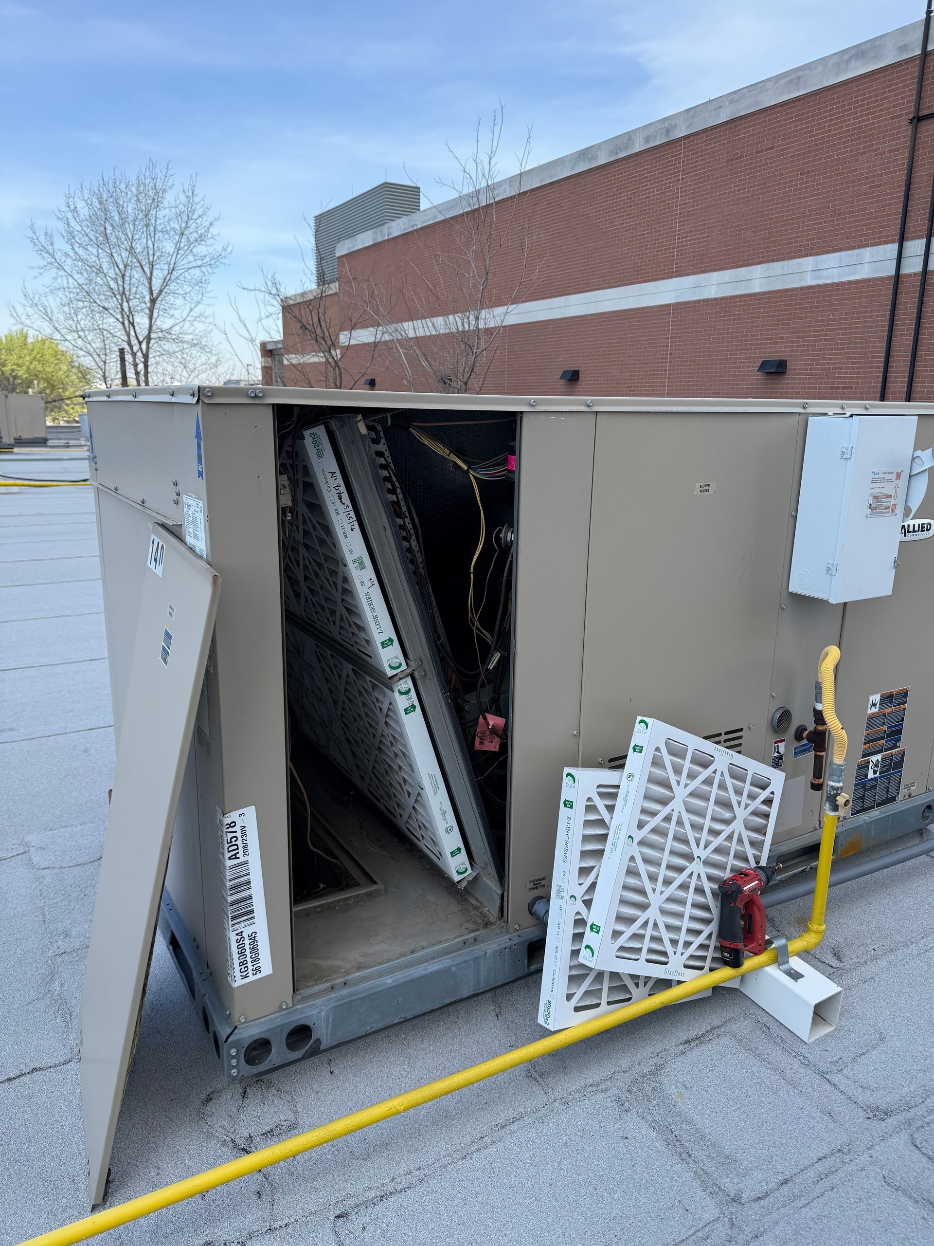 A white truck is parked in a parking lot next to a building.