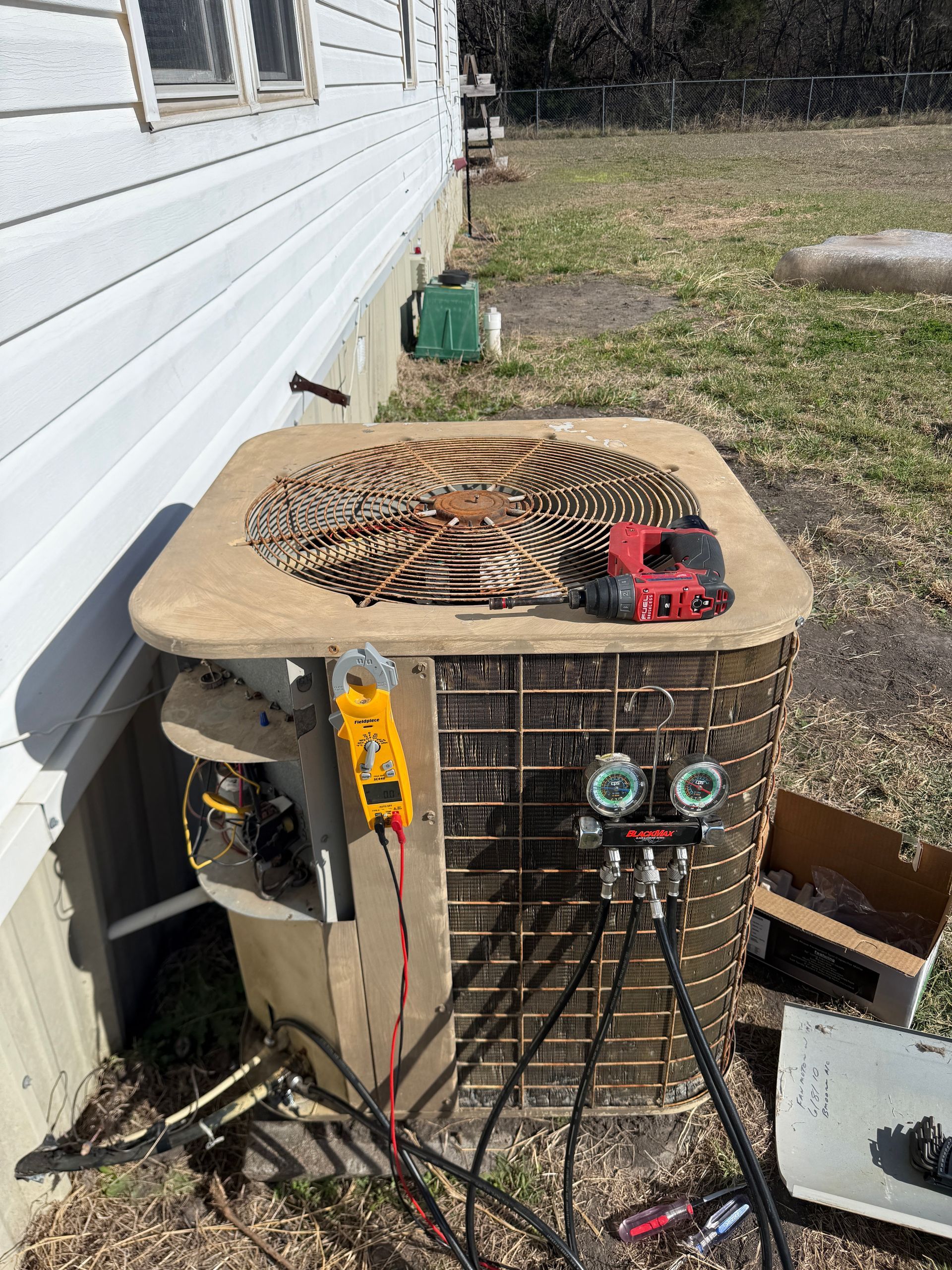 A white truck is parked in a parking lot next to a building.