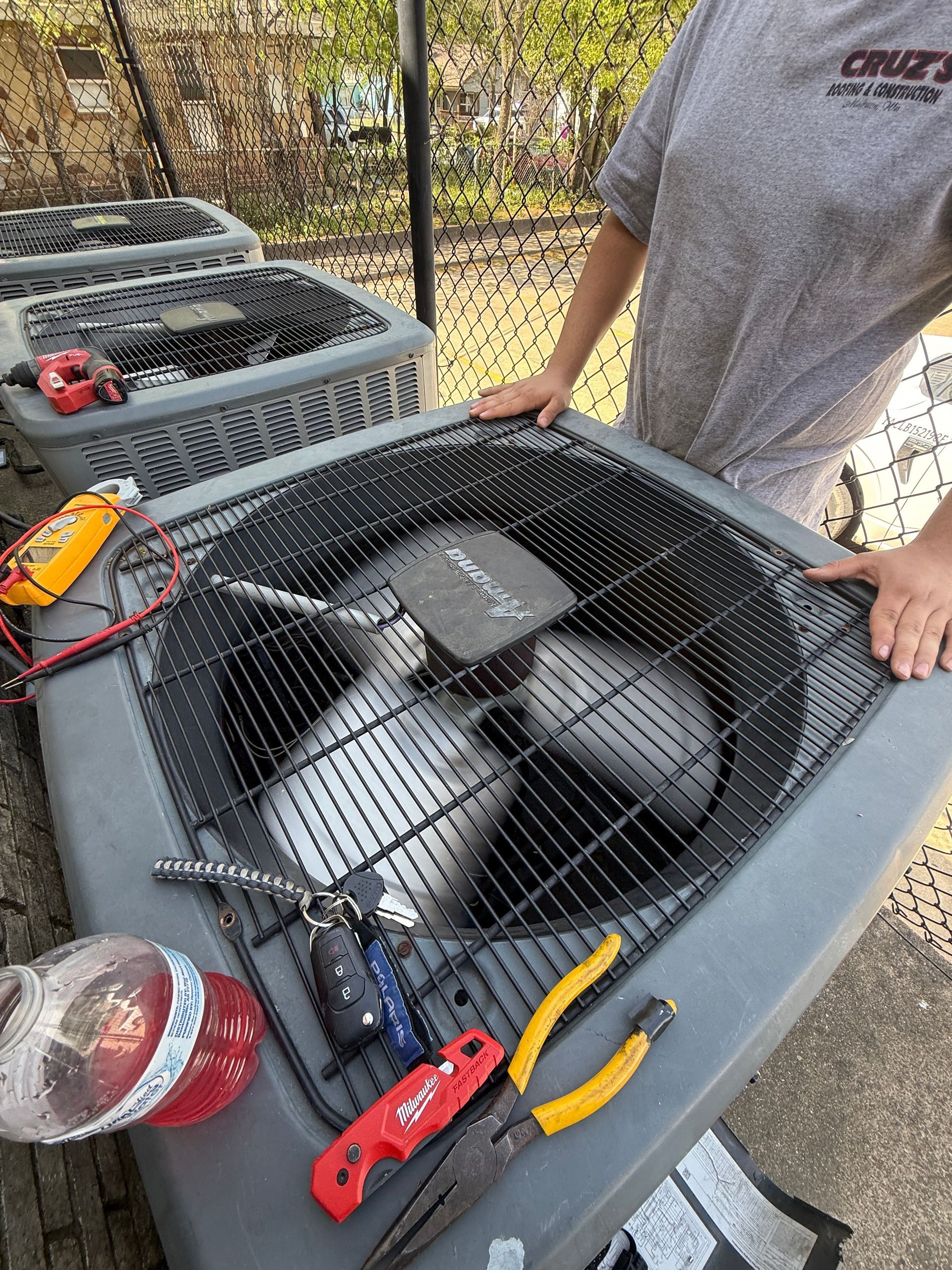 A white truck is parked in a parking lot next to a building.