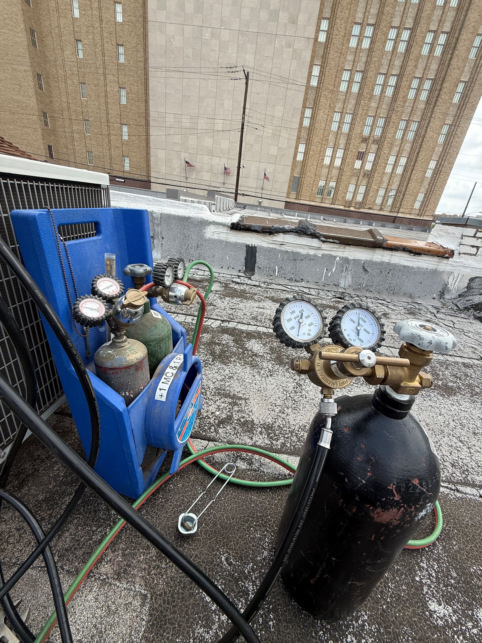 A white truck is parked in a parking lot next to a building.