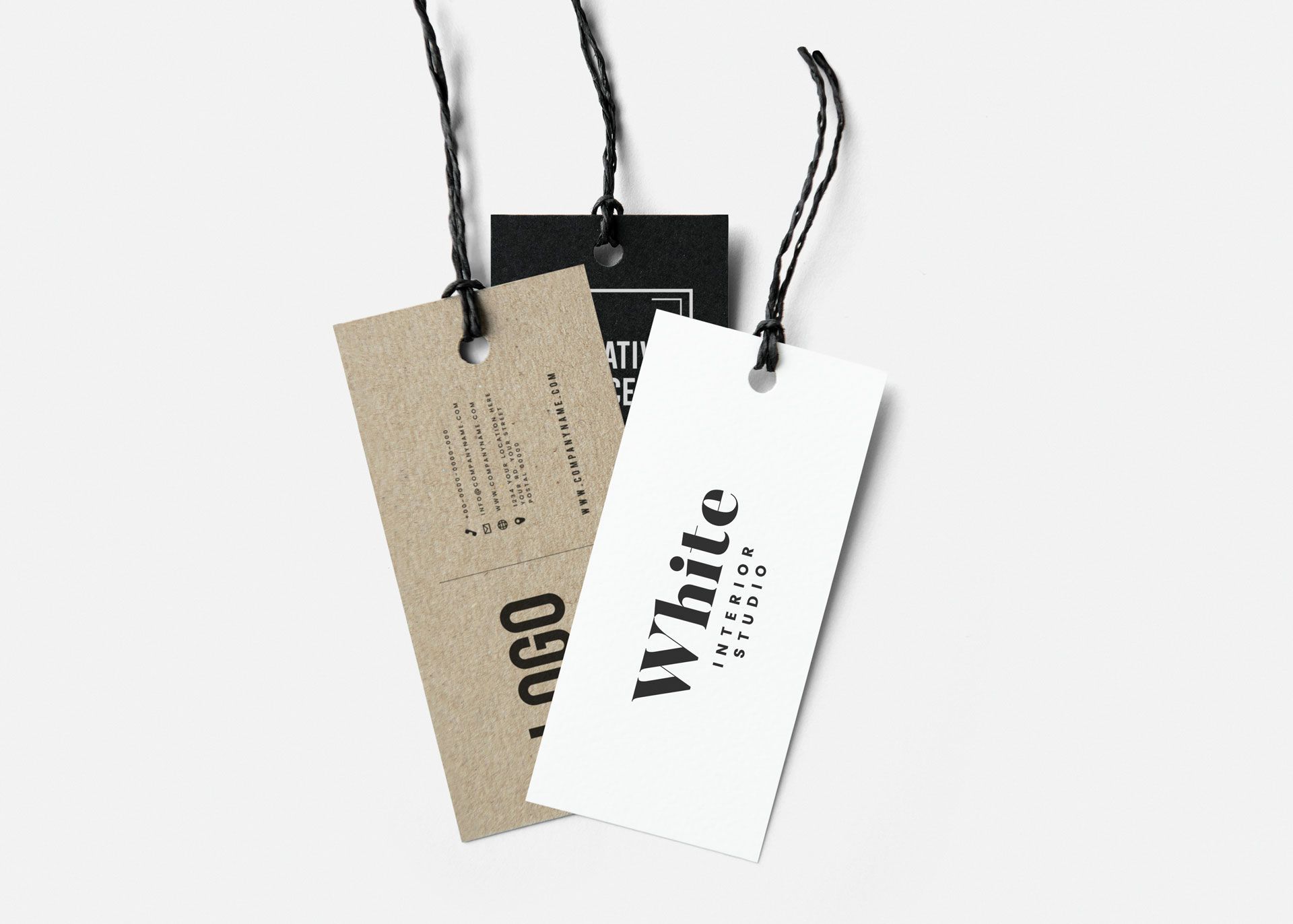 Three hanging clothing tags: a white one labeled 