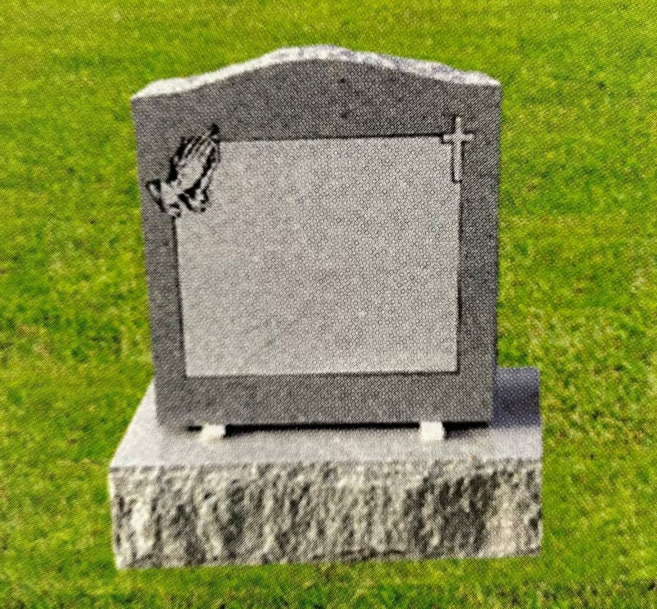 Headstone with blank center, cross, and praying hands detail, on grassy ground.
