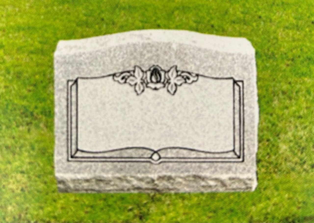 Gray rectangular tombstone with blank inscription area, floral design, on green grass.