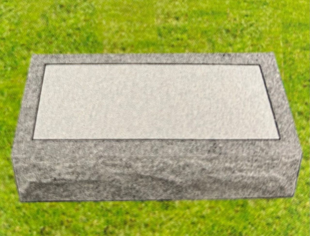 Flat granite tombstone on green grass.
