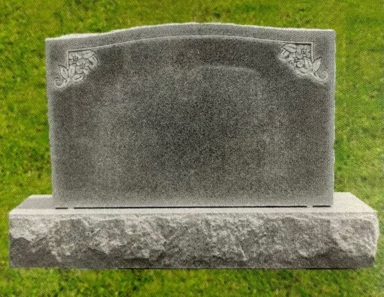 Gray granite headstone on a rectangular base, etched with a diamond pattern, set on a green lawn.