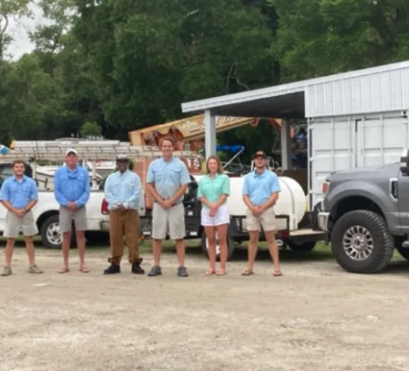 A man is cleaning a patio with a high pressure washer.