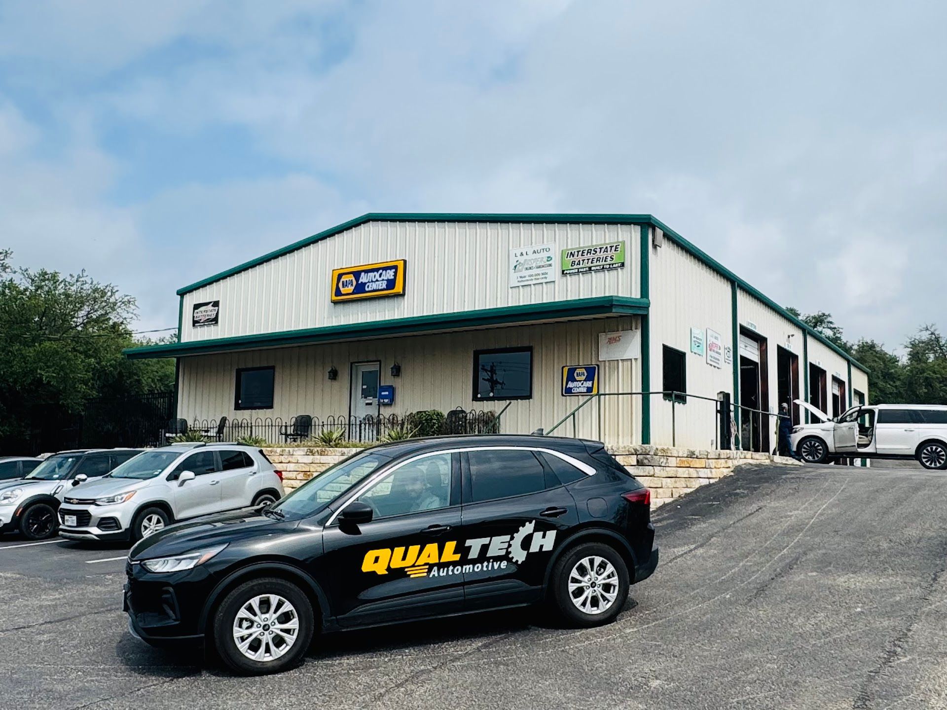 Black SUV in front of shop | QualTech Automotive