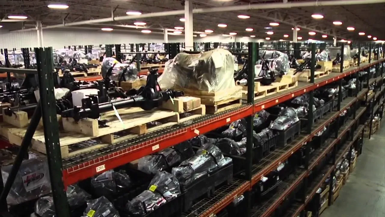 A large warehouse filled with lots of parts on shelves.