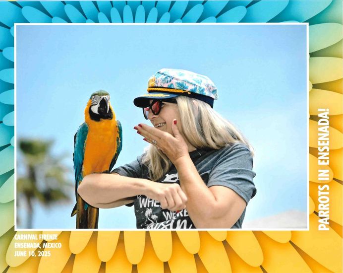 A woman wearing a hat and sunglasses is standing next to a fence.