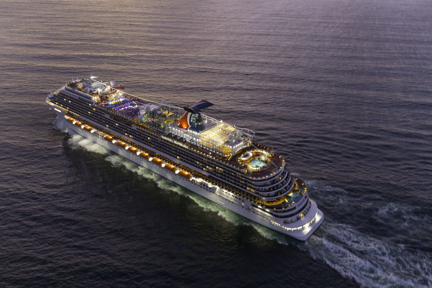 An aerial view of a cruise ship floating on top of a body of water.