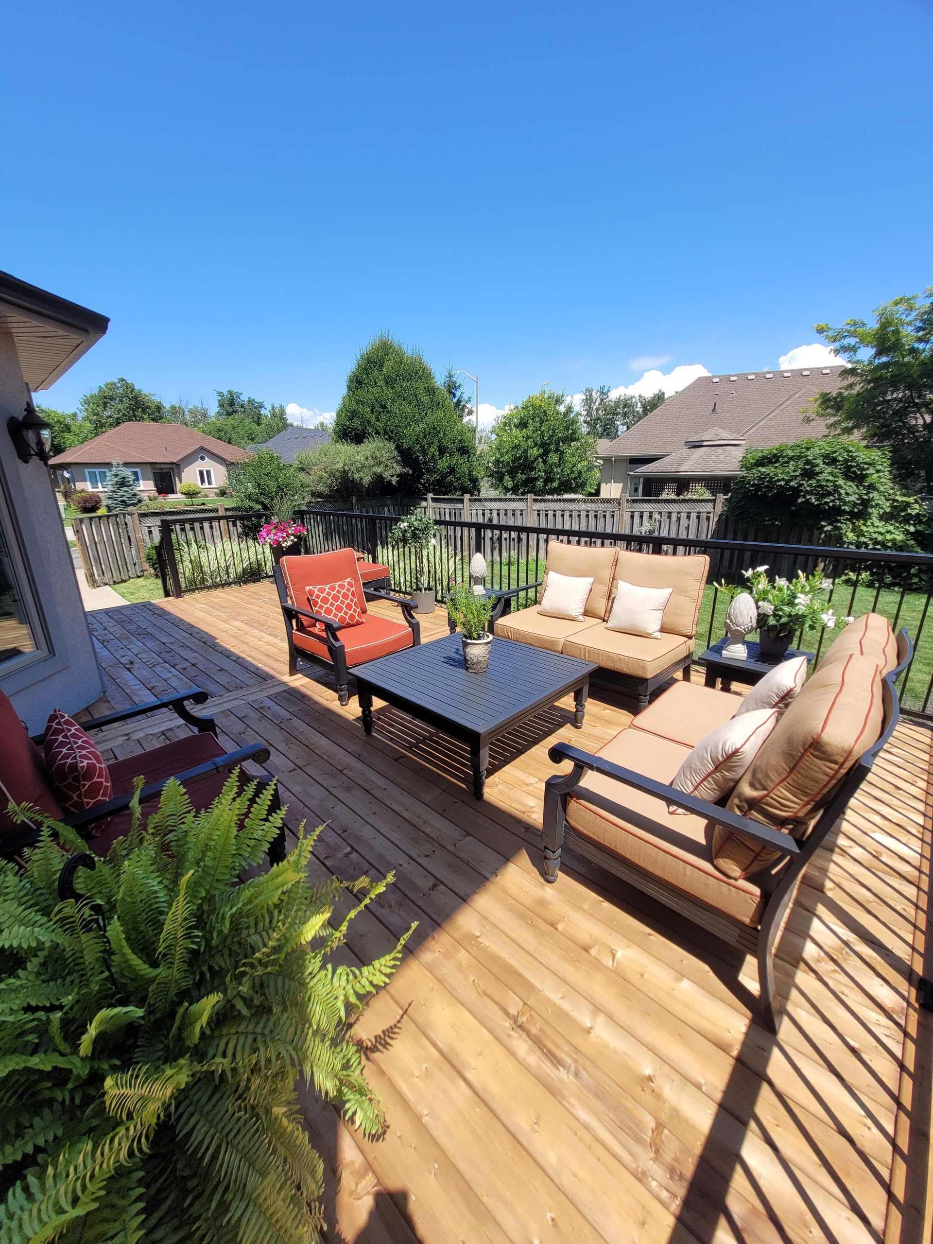 Wooden deck with outdoor furniture on a sunny day.