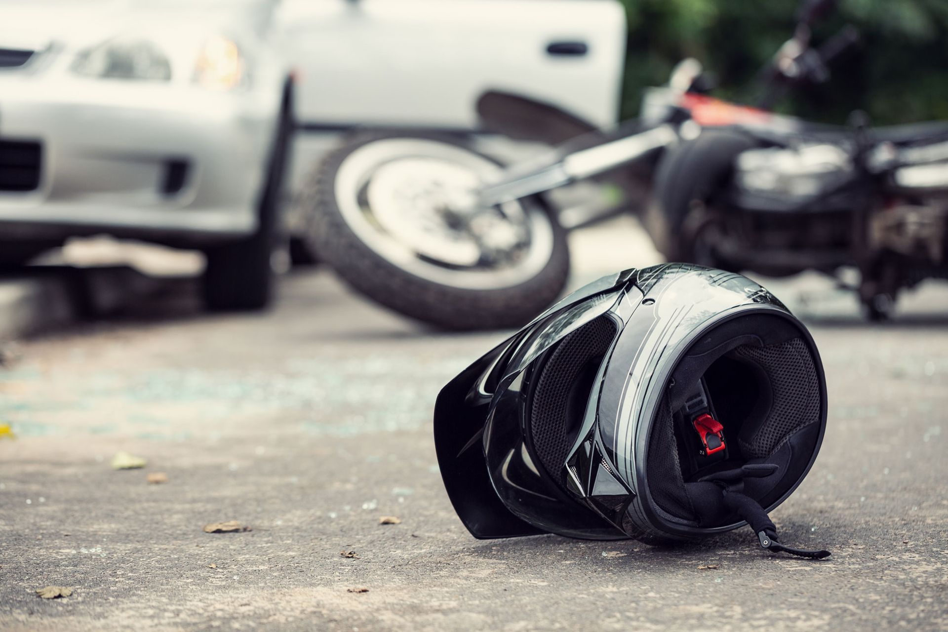 Motorcycle helmet with a blurred accident scene in the background, highlighting the need for a motor