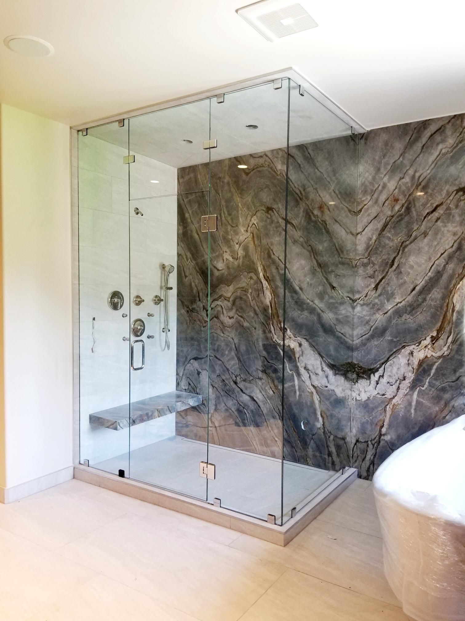 A bathroom with a walk in shower and a bathtub.