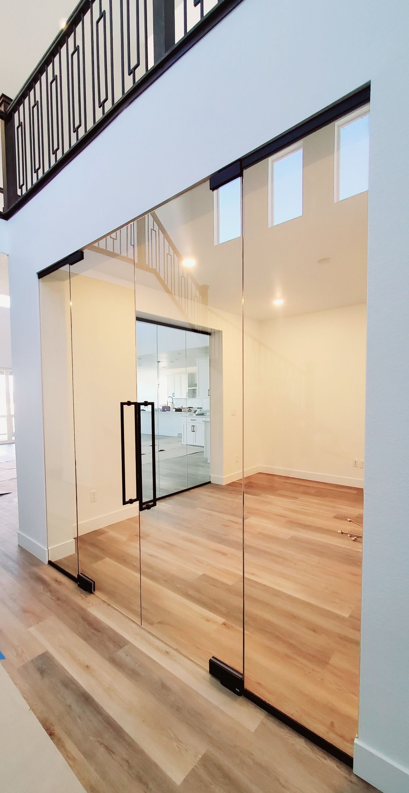 A room with a wooden floor and a glass door.
