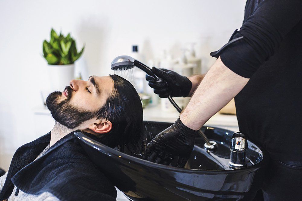 Man Getting Hair Washed at Hairdresser | Cheyenne, WY | City Barbers & Stylists