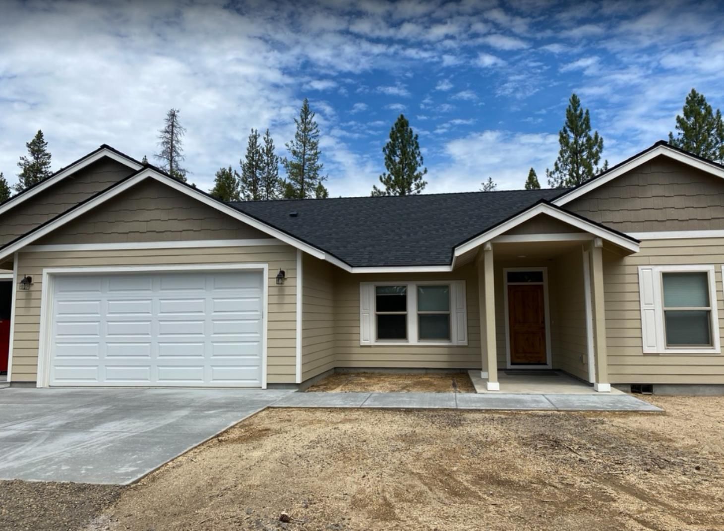 A house with a large garage and a porch