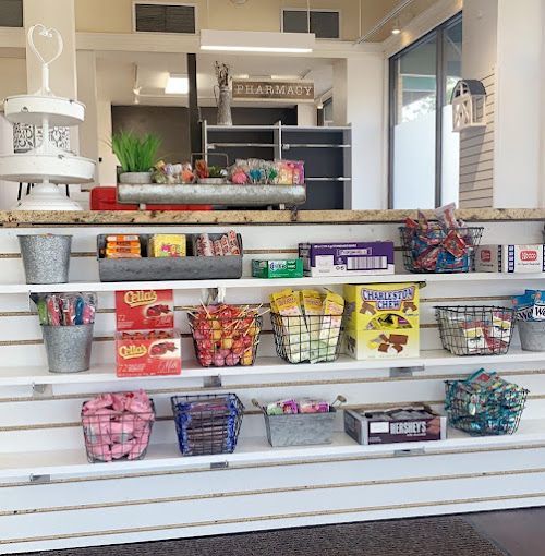 A candy store with a sign that says ' pharmacy ' on it