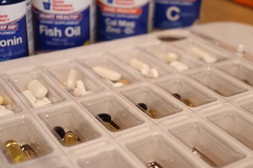 A tray of pills and bottles of fish oil