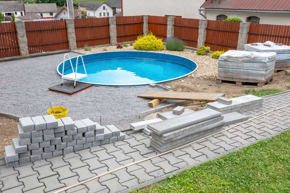 A swimming pool is being built in a backyard.