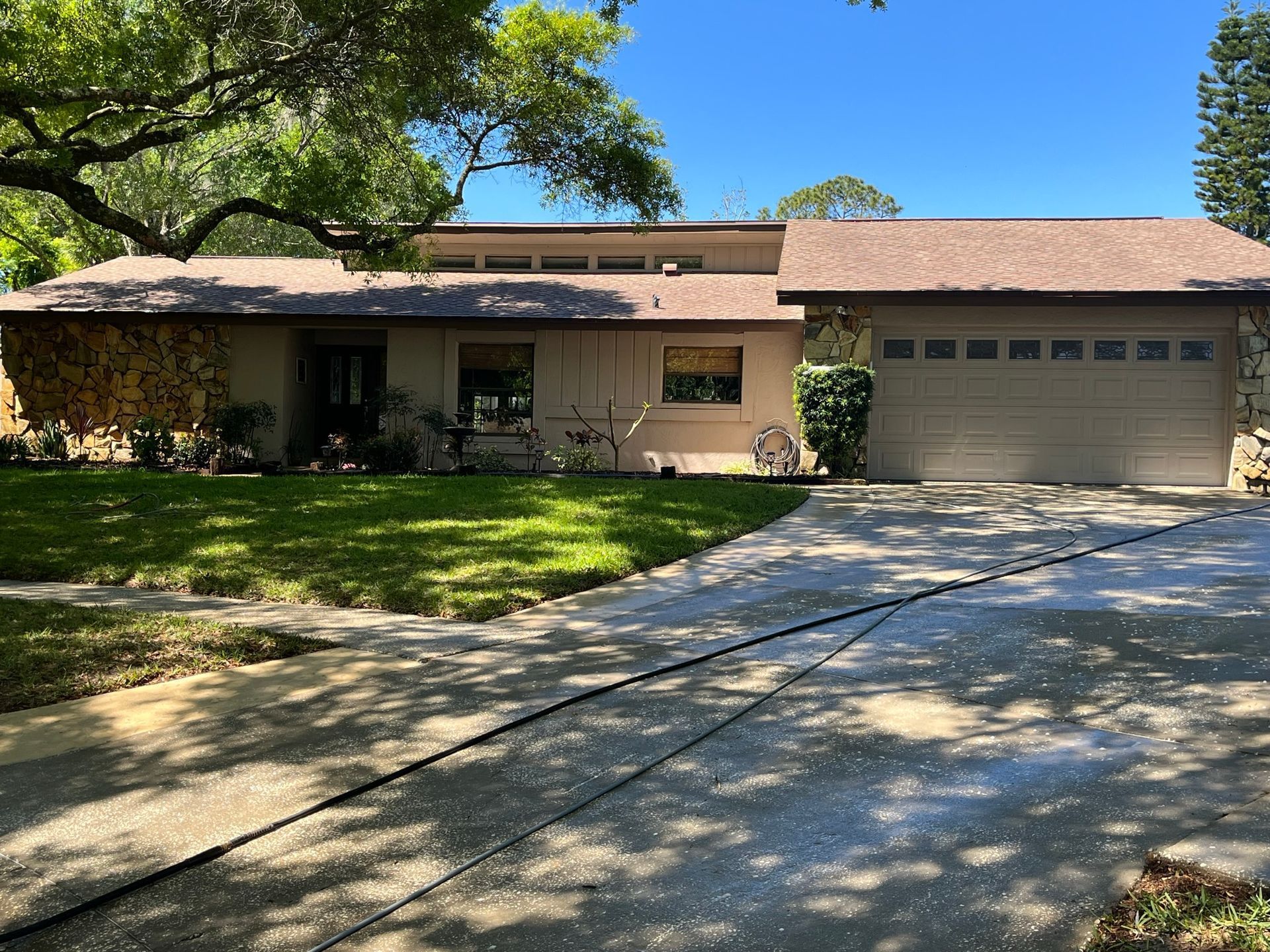 A house with a garage and a driveway in front of it