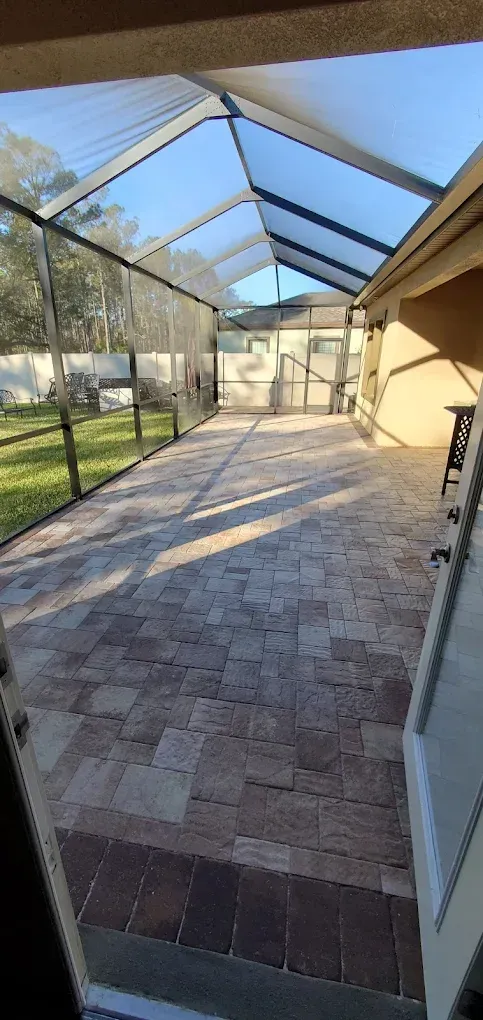 A view of a screened in patio from the inside of a house.