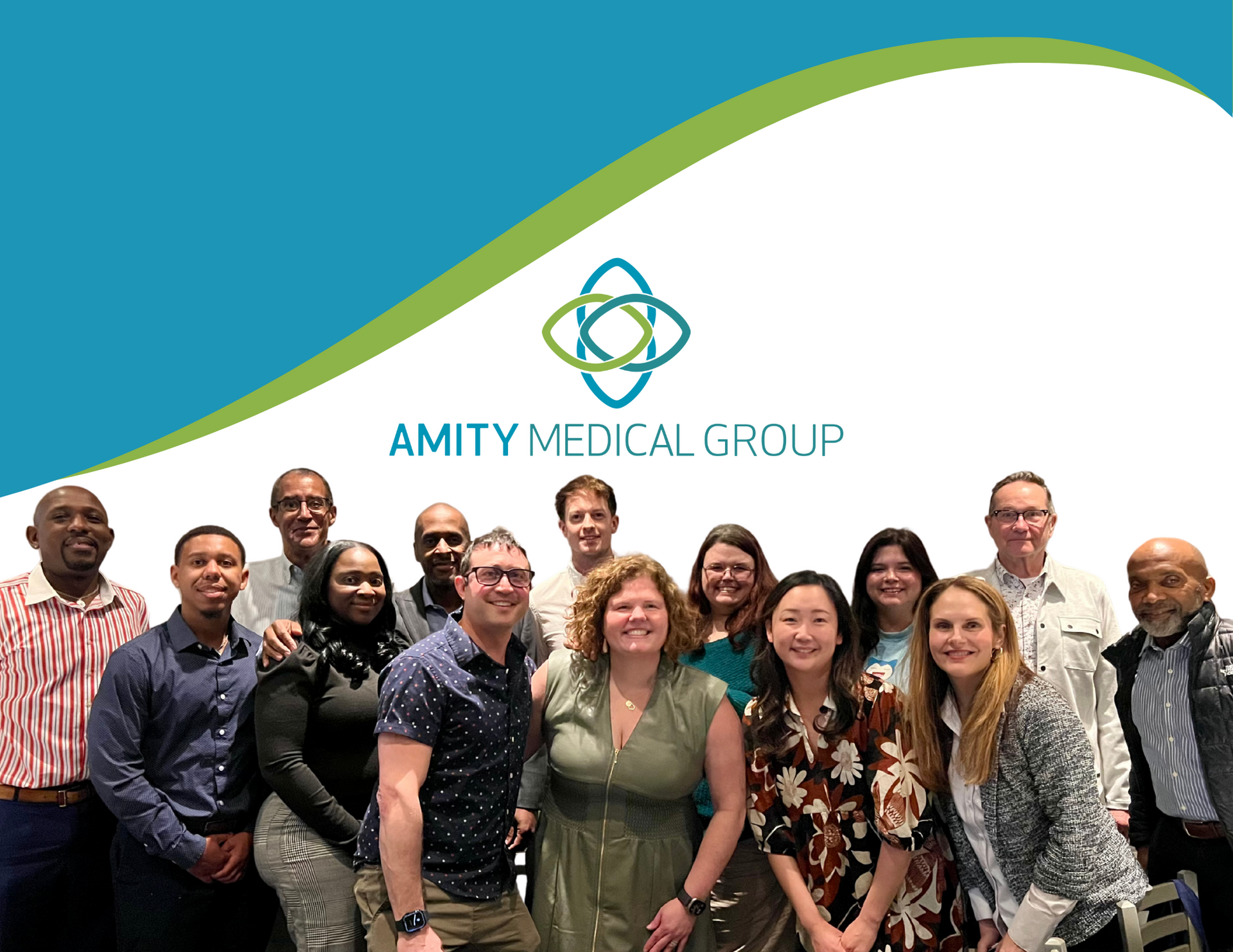 A group of people are posing for a picture in front of the amity medical group logo.