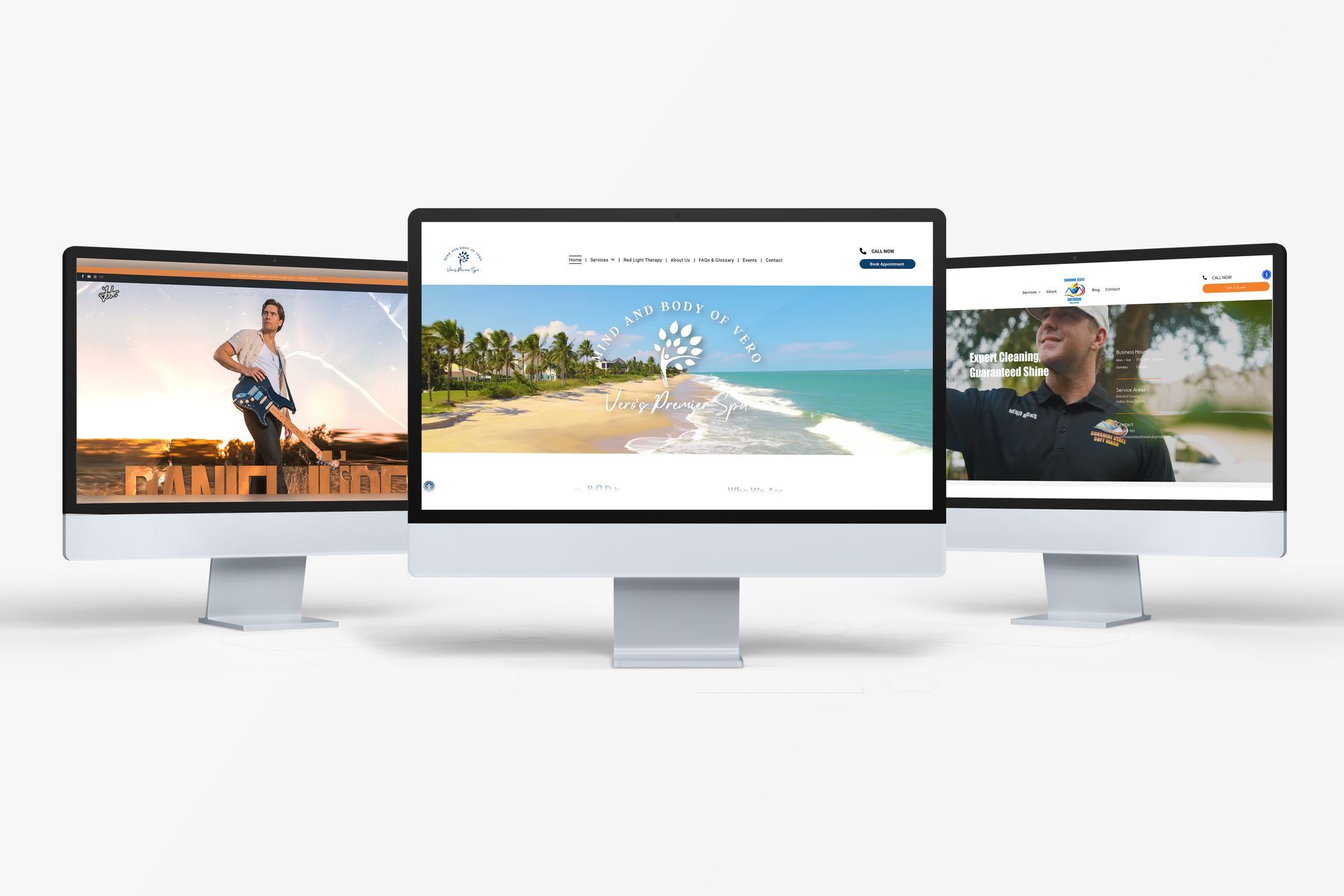 Three computer monitors are sitting next to each other on a table.
