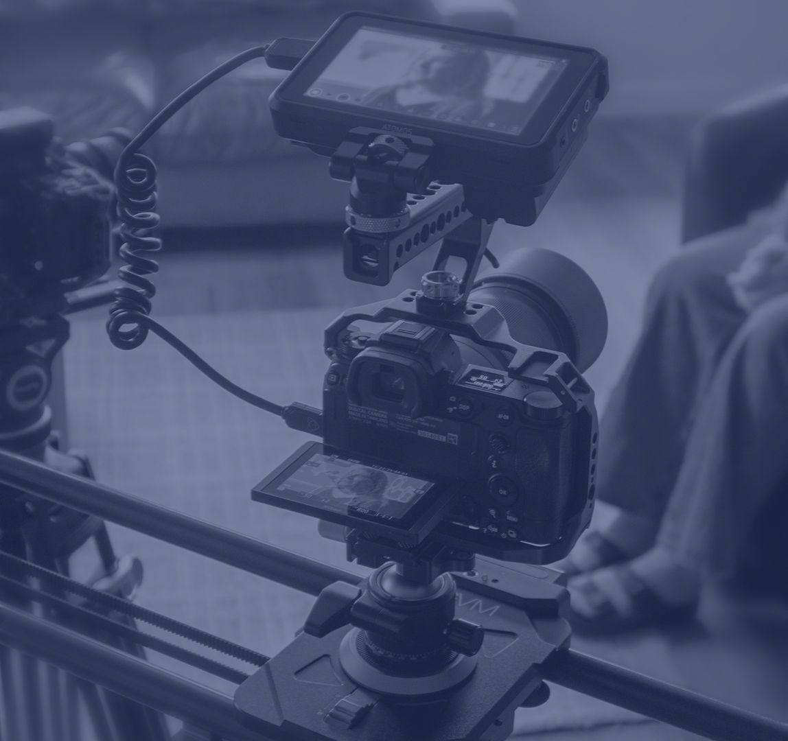 Camera on a tripod with an external monitor.