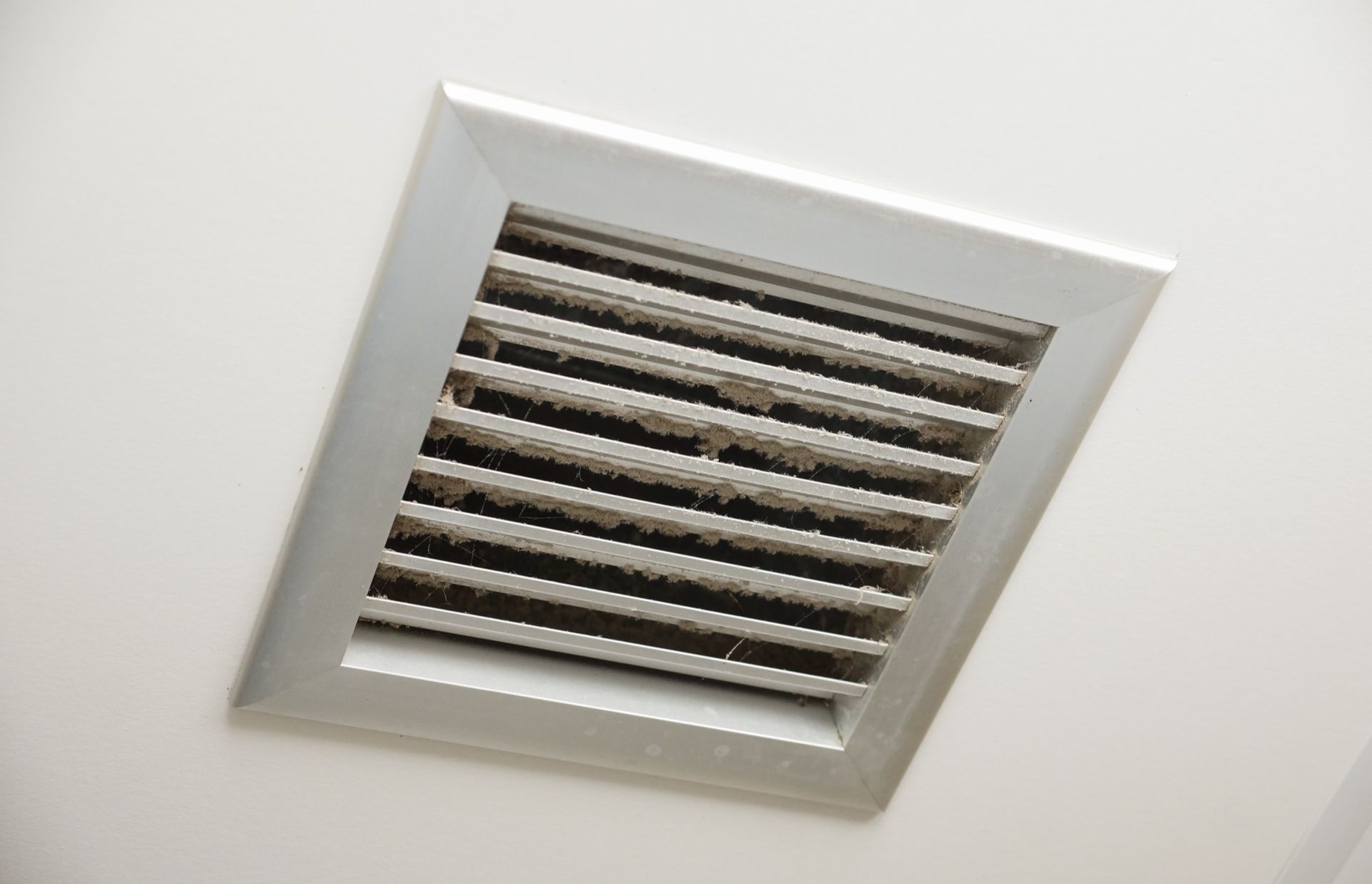 Looking through the vents of an AC unit a fan blade stays motionless