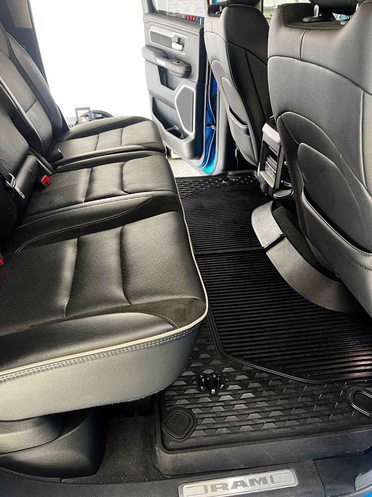 The back seat of a ram truck with the door open