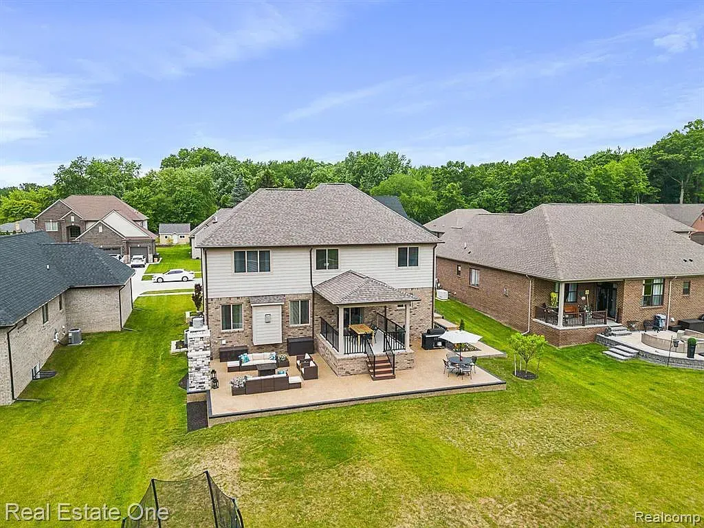 An aerial view of a large house with a large lawn in front of it.