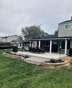 A house with a large patio in the backyard.
