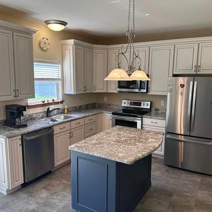 A kitchen with stainless steel appliances and granite counter tops.