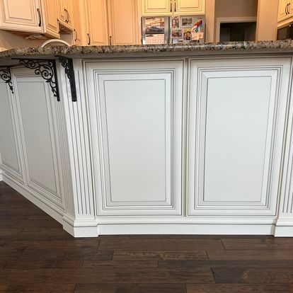 A kitchen with white cabinets and a granite counter top.