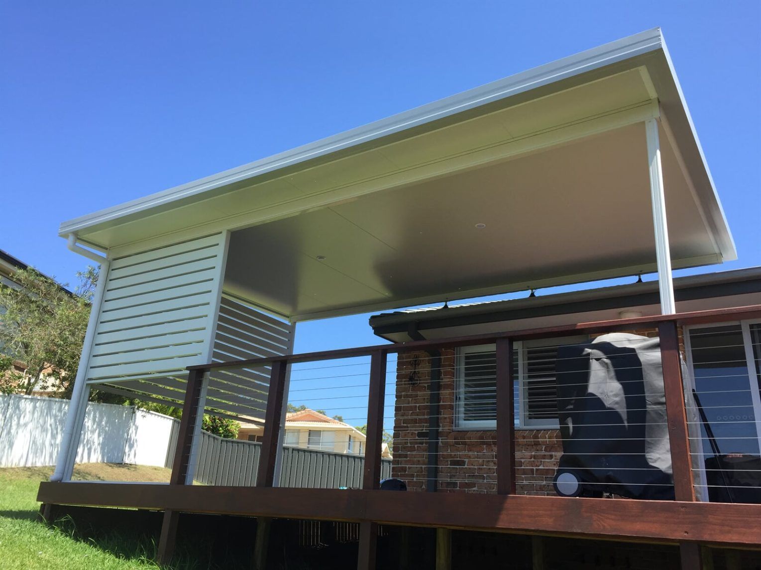 A house with a wooden deck and a white roof. — Hunter & Mid Coast Patios In Lake Macquarie, NSW