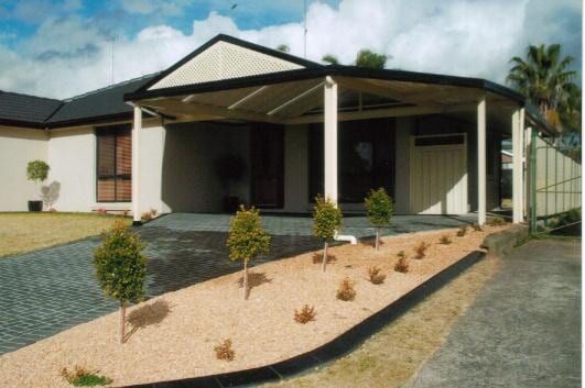 A House With a Large Deck and Stairs Leading Up to It — Hunter & Mid Coast Patios In Hamilton, NSW