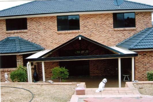 A House With a Large Deck and Stairs Leading Up to It — Hunter & Mid Coast Patios In Port Stephens, NSW