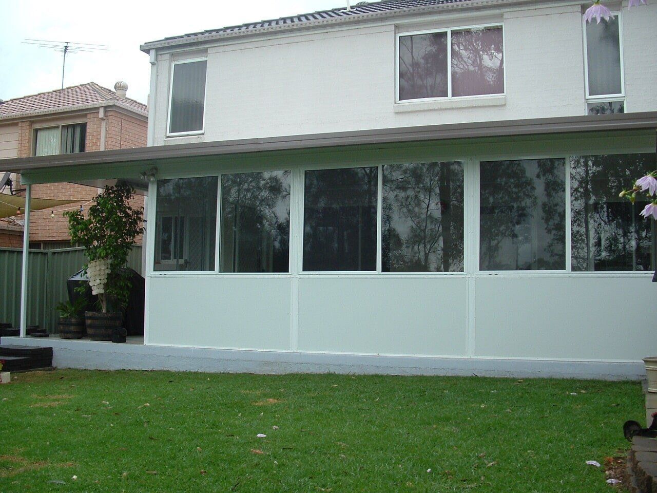 A House With a Large Deck and Stairs Leading Up to It — Hunter & Mid Coast Patios In Port Stephens, NSW
