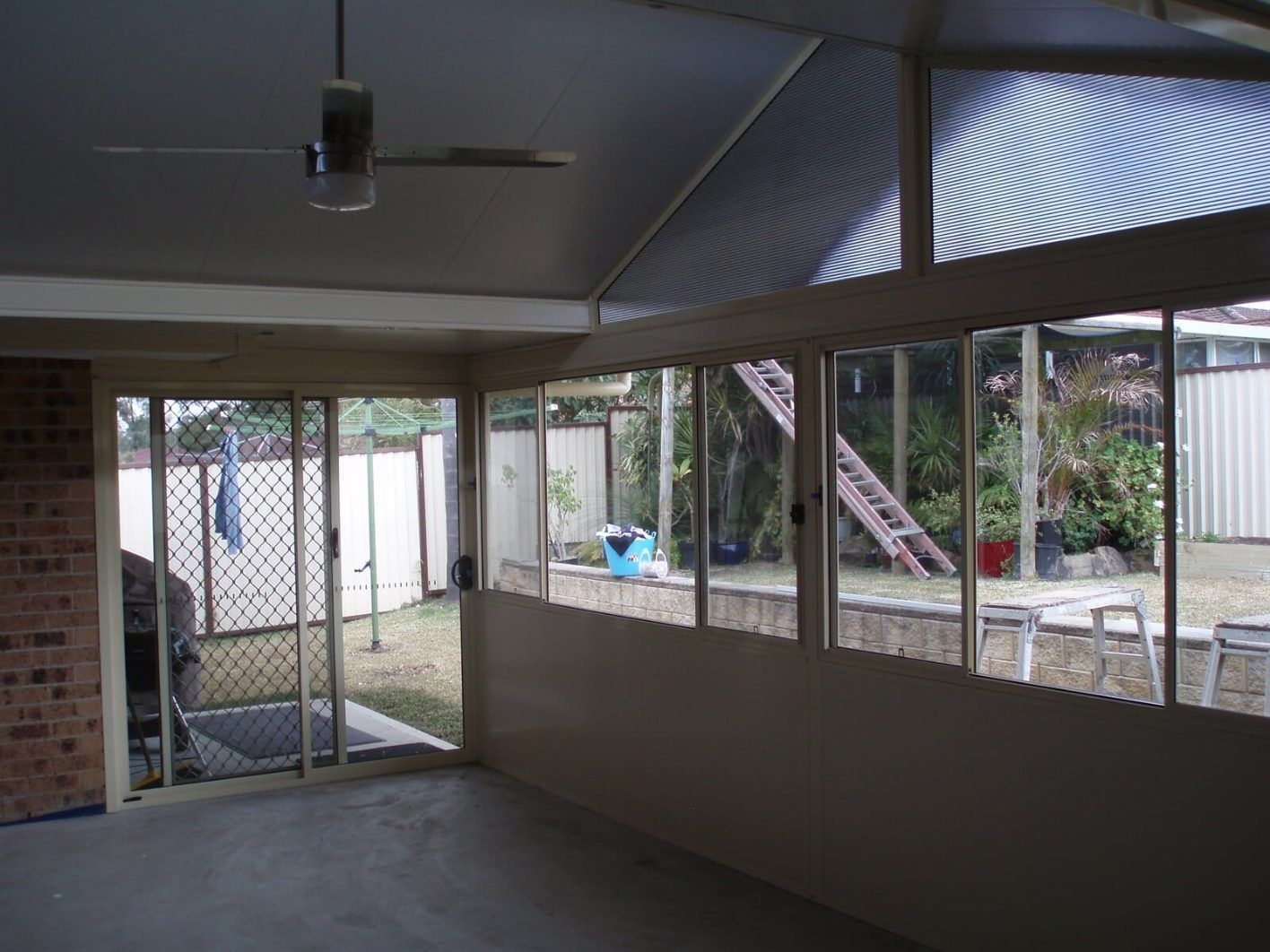 A Room With a Lot of Windows and a Ceiling Fan — Hunter & Mid Coast Patios In Lake Macquarie, NSW