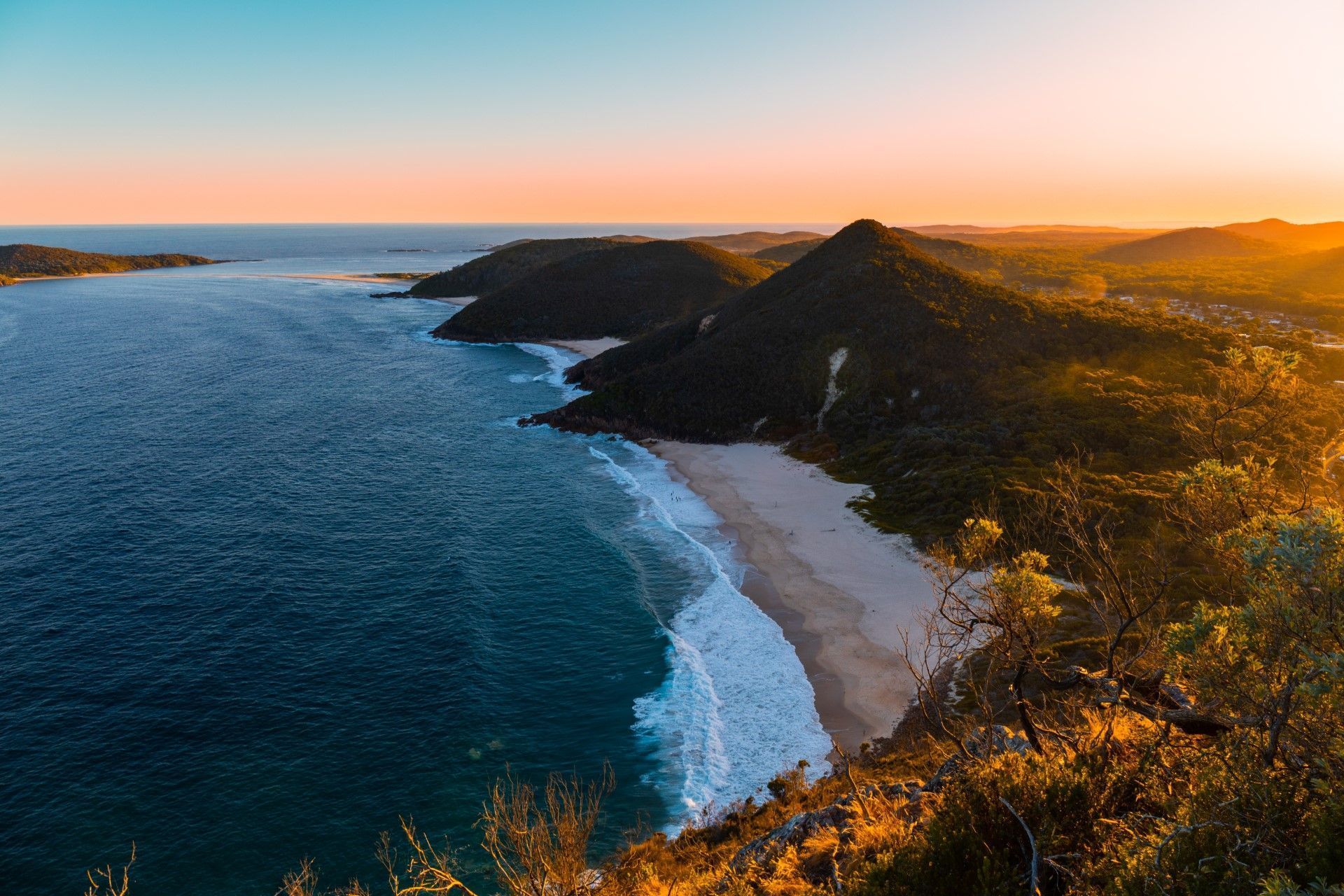 An Aerial View of a Beach and Ocean at Sunset — Hunter & Mid Coast Patios In Port Stephens, NSW