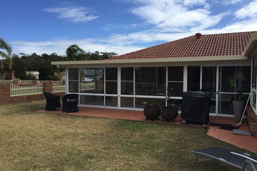 A House With a Large Deck and Stairs Leading Up to It — Hunter & Mid Coast Patios In Hamilton, NSW