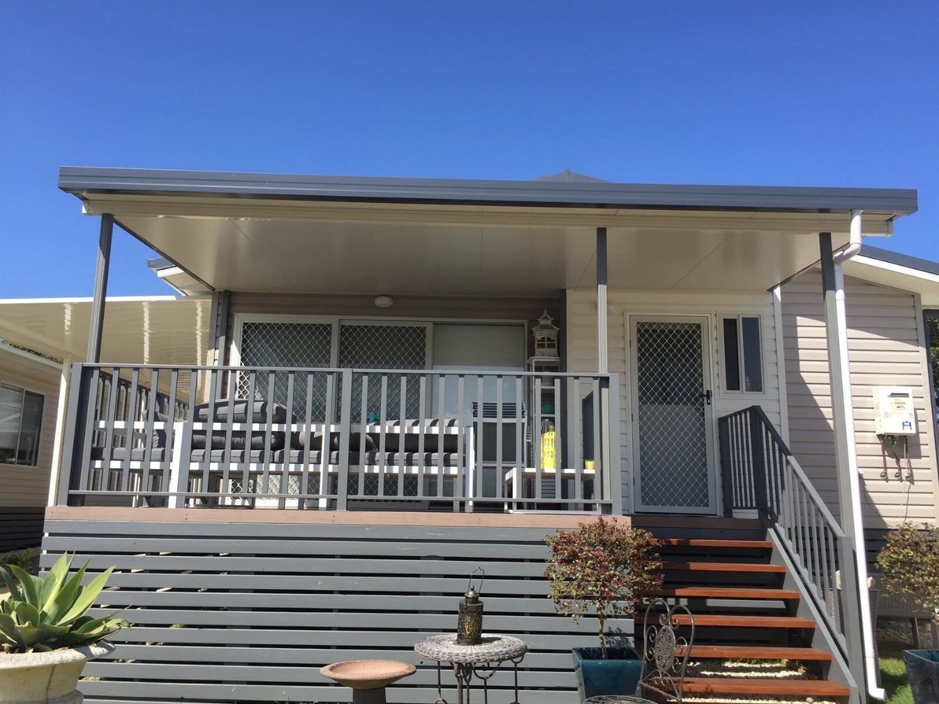 A House With a Large Deck and Stairs Leading Up to It — Hunter & Mid Coast Patios In Lake Macquarie, NSW