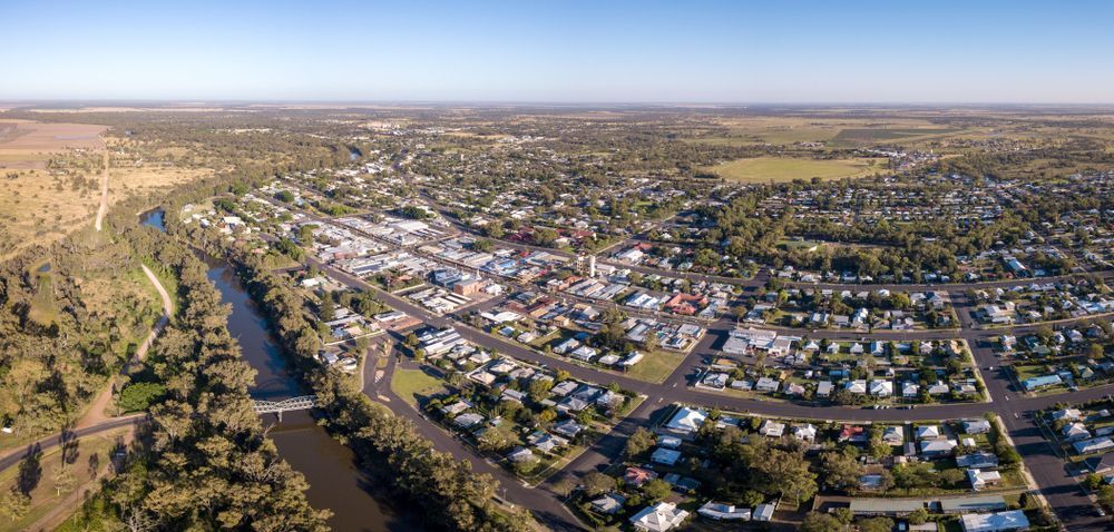An Aerial View of a Small Town Surrounded by Trees and a River — Gardners Yamba Skip Bin Hire in Gulmarrad, NSW