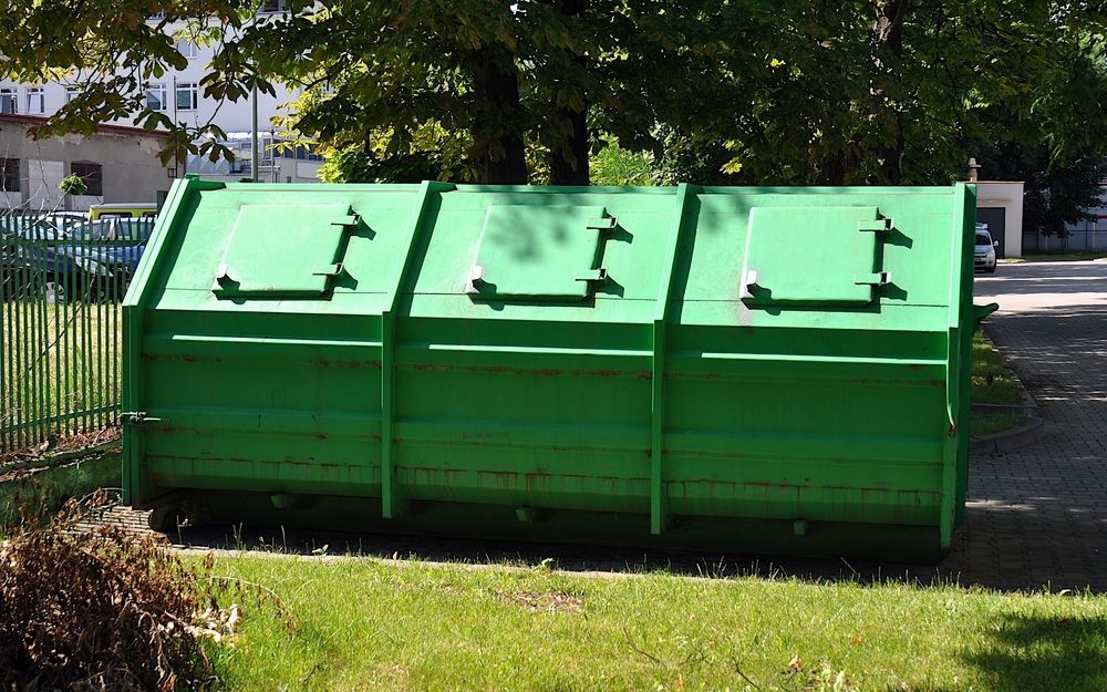 A Bulldozer is Driving Through a Dirt Field on a Cloudy Day — Gardners Yamba Skip Bin Hire In South Grafton, NSW