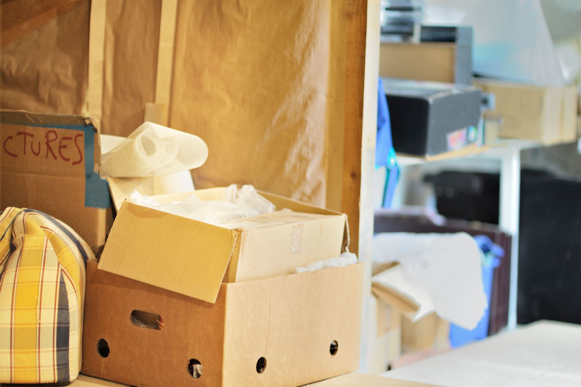 A stack of cardboard boxes sitting on top of each other in a room.
