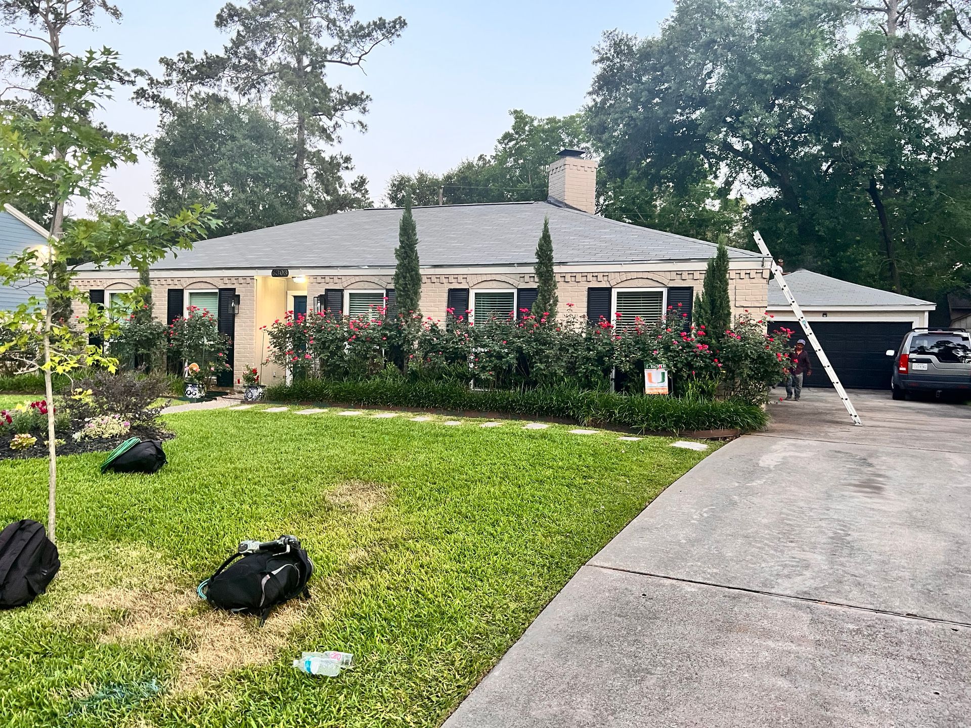 A one-story house with new gray roof replacement