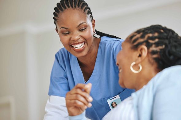 Smiling nurse tends to patient